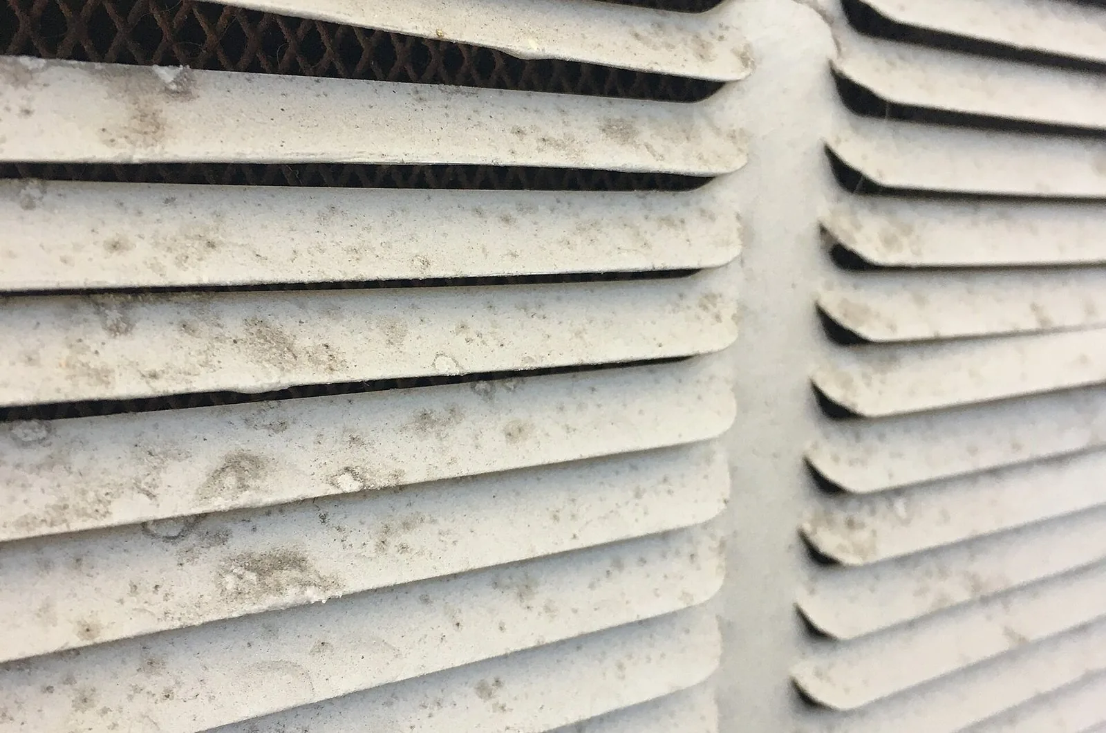 Close view of dust on the slats of a ventilation louvre